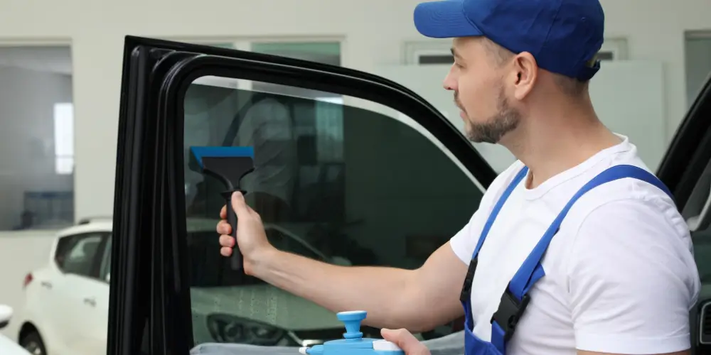 Professional removing window tint to a car