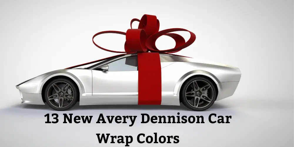 A sleek silver sports car wrapped with a large red bow, highlighting the newest Avery Dennison car wrap colors for premium vehicle customization.