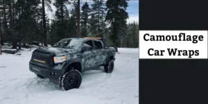 A rugged truck with a camouflage car wrap parked in a snowy forest, showcasing its bold design and durability.