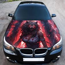 A black car with a custom hood design featuring a fierce, red-toned werewolf illustration surrounded by dramatic lighting effects