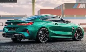 A striking green luxury coupe with a sporty design, parked outdoors with an industrial background.