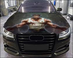 Custom car hood wrap featuring a bold illustration of a muscular superhero character on a black vehicle.